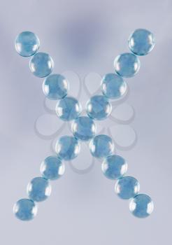 Close-up of marble balls arranged in the shape of letter X