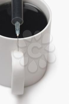Coffee cup with a syringe