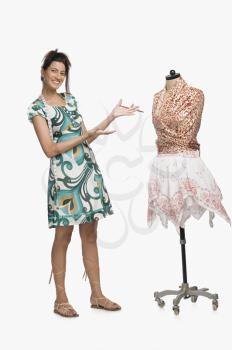 Female fashion designer showing a dress
