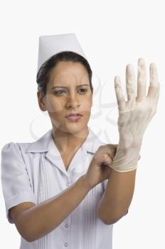 Female nurse wearing a surgical glove