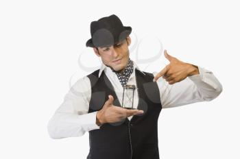 Businessman holding an hourglass and pointing at it