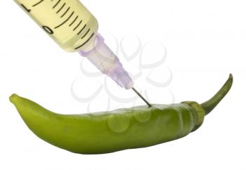 Green bell pepper being injected with a syringe