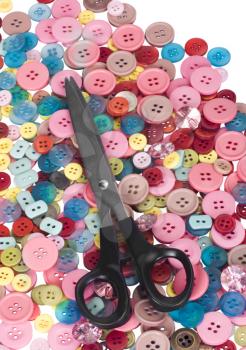 Scissors on a heap of buttons