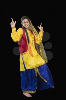 Woman in traditional Punjabi dress dancing