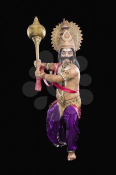 Portrait of a stage artist dressed-up as Ravana the Hindu mythological character and holding a mace