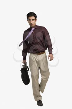Portrait of a businessman pulling a bag