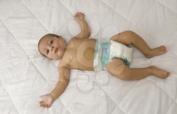 High angle view of a baby boy lying on the bed