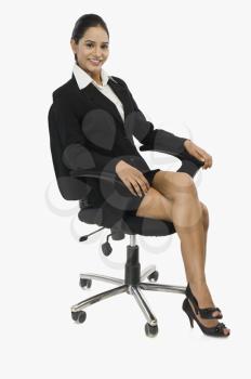 Businesswoman sitting on a chair and smiling