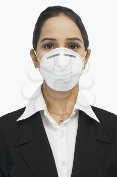 Close-up of a businesswoman wearing an H1N1 mask