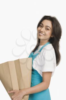 Portrait of a woman holding a paper bag