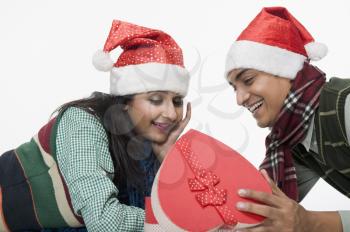 Couple lying on a floor with a Christmas present