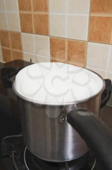 Milk boiling over a pan