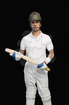 Portrait of a cricket batsman holding a cricket bat