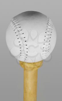 Baseball balancing on the top of a bat handle