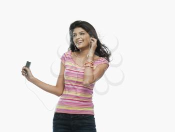 Woman listening to an mp3 player and dancing