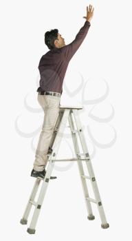 Businessman on a ladder