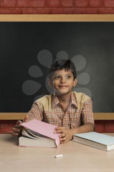 Boy imitating a teacher in a classroom and day dreaming