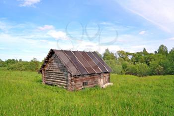 old rural house on green field
