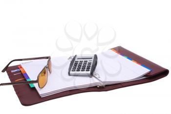 Outdoor notebook book with glasses and a calculator on a white background. 
                   