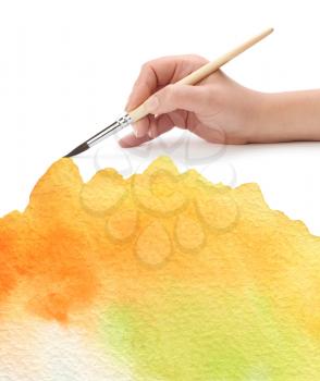 hand with paint brush and color painted background
