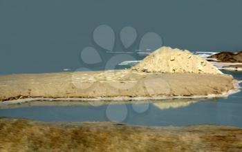 sandy montains are reflected in waters of the dead sea