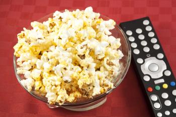 Royalty Free Photo of a Bowl of Popcorn and Remote Control