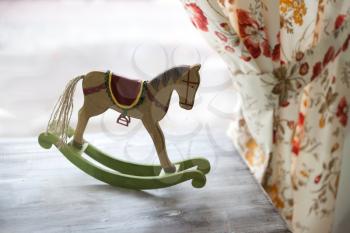 Horse toy on vintage background with curtaine