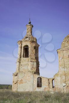 Old destroyed and abandoned church against the blue sky