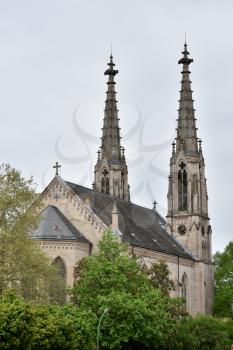 Beautiful and tall towers on evangelical church in Europe against the sky