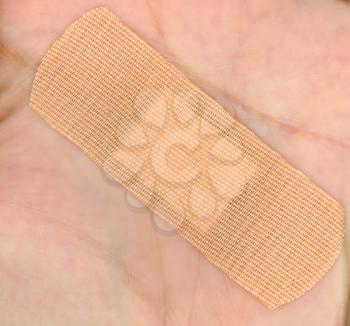 a medical self adhesive bandage band aid on hand