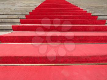 Red carpet on a stairway to mark the route of heads of state, vips and celebrities on ceremonial and formal occasions or events
