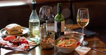Wine drink glasses, snacks on the pub table