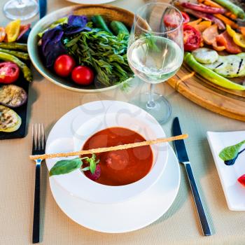 Tasty red tomato soup and vegetable with white wine