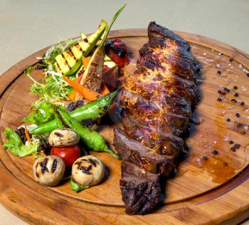 Fresh Steak with fire on it, wooden plate