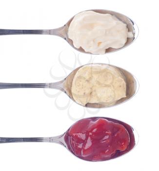 Royalty Free Photo of Mayonnaise, Mustard and Ketchup on Silver Spoons 