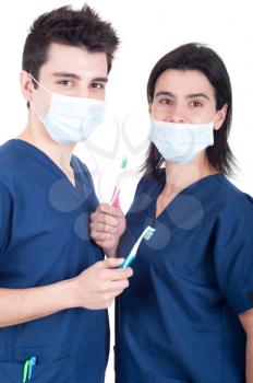 Royalty Free Photo of Two Doctors Holding Toothbrushes