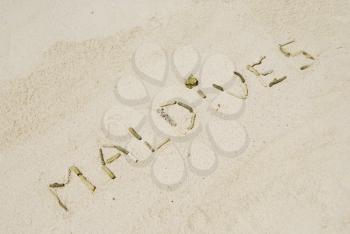 Royalty Free Photo of a Maldives Note Written on a Beach
