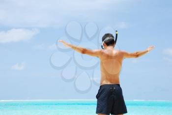 Royalty Free Photo of a Man Snorkeling on a Beach