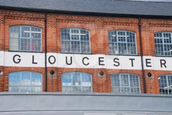 Royalty Free Photo of a Brick Building With a Gloucester Sign