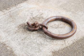 Royalty Free Photo of a Rusty Mooring Ring for Ships on Dock