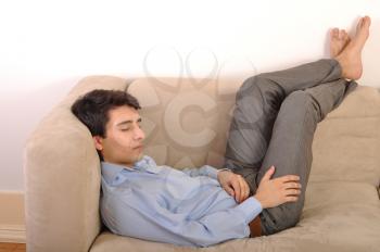 Royalty Free Photo of a Man Sleeping on a Couch
