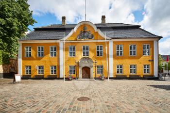 a danish town hall building in yellow