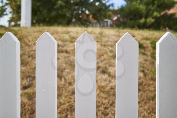 Closeup of a white-picket fence
