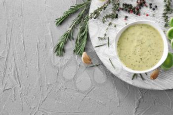 Tasty sauce in bowl on grey background�
