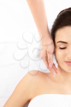 Young woman receiving face massage on white background, top view. Spa procedures�