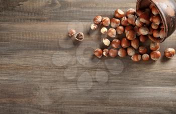 Scattered hazelnuts on wooden table�