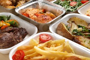 Different containers with delicious food, closeup. Delivery service�