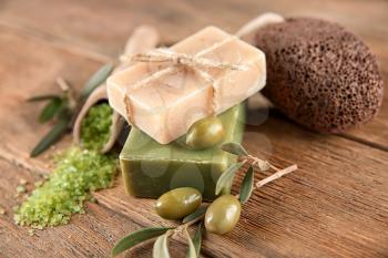 Bars of natural soap with olive extract on table�