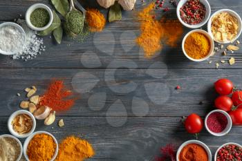 Frame made of various spices on wooden table�