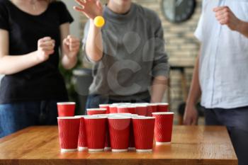 People playing beer pong in bar�